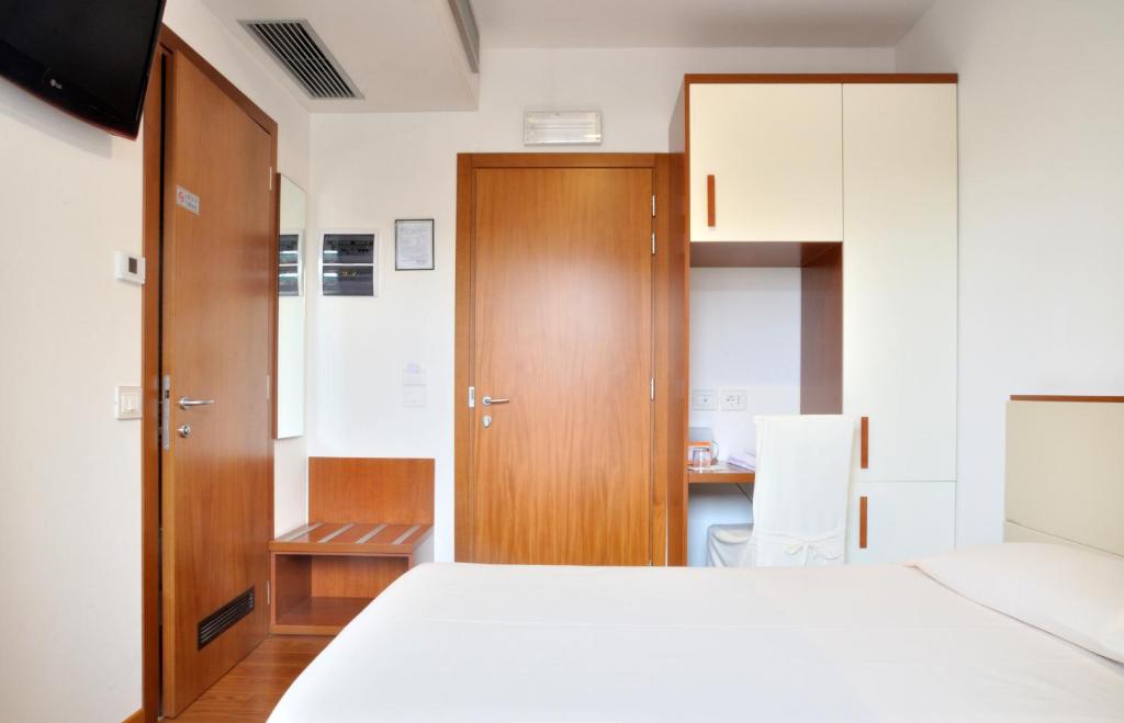 Postel nebo postele na pokoji v ubytování Hotel Mezzaluna