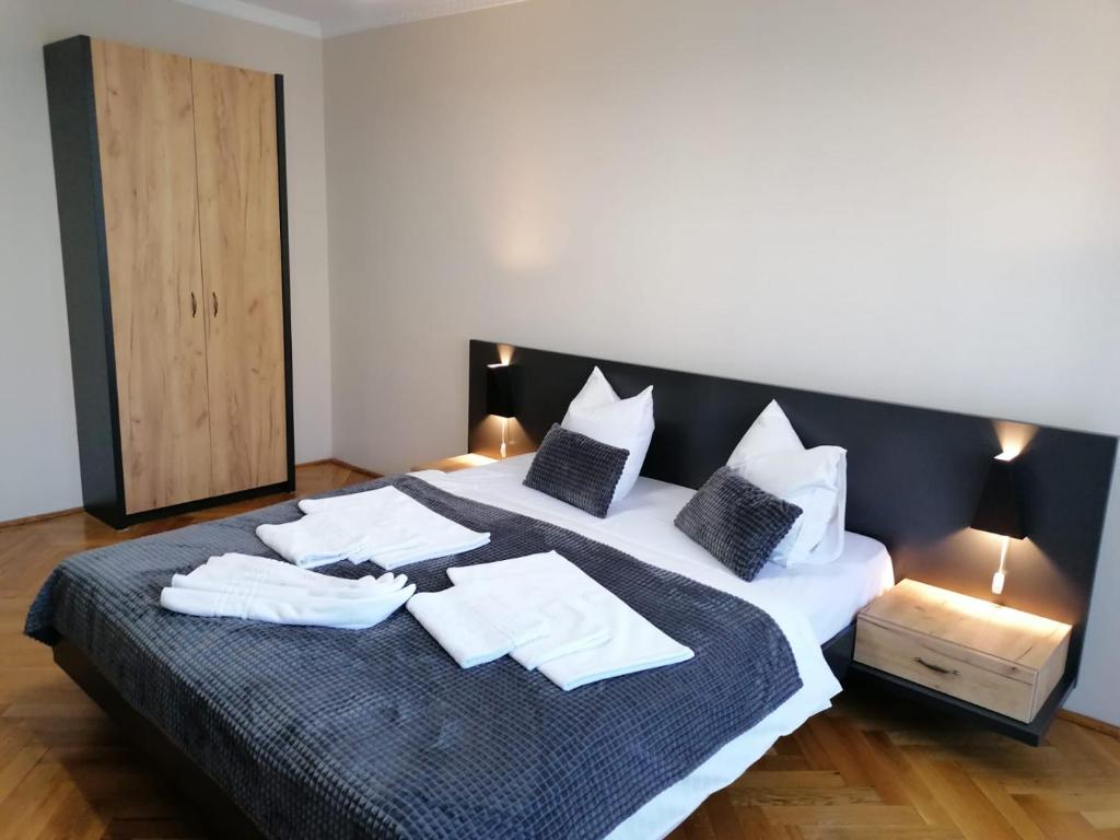 a bedroom with a large bed with white sheets and pillows at Apartament Alena in Baile Felix