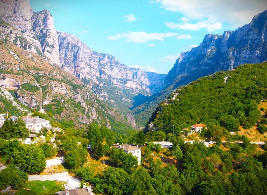 a village in a valley in the mountains at Vikos View in Aristi