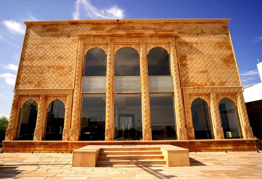 a building with a large window and stairs in front at 1st Luxury in Rāmdevra