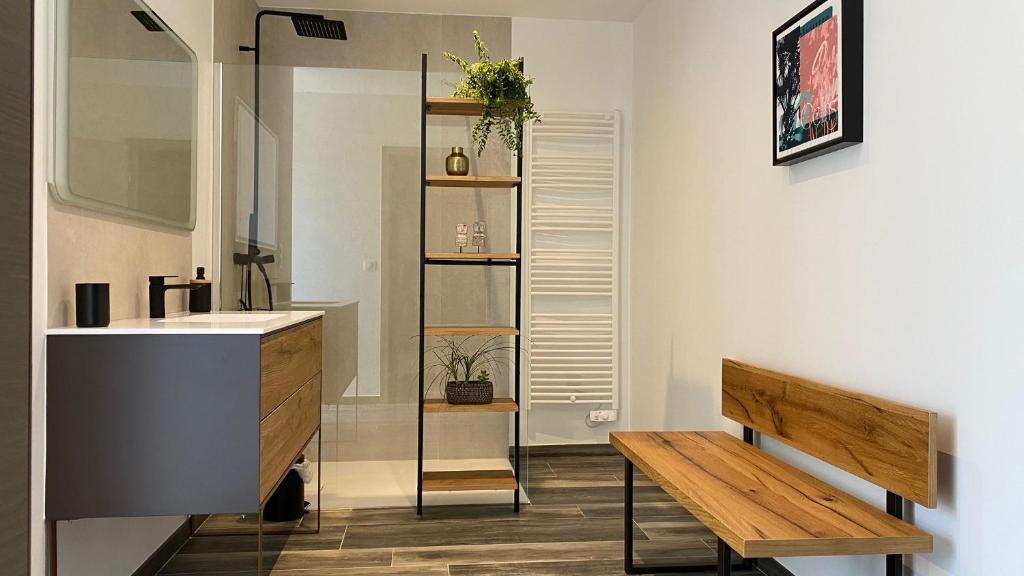 a bathroom with a sink and a wooden bench at LES ROCHES DE BAUDISSET in Saint-Paul-en-Forêt