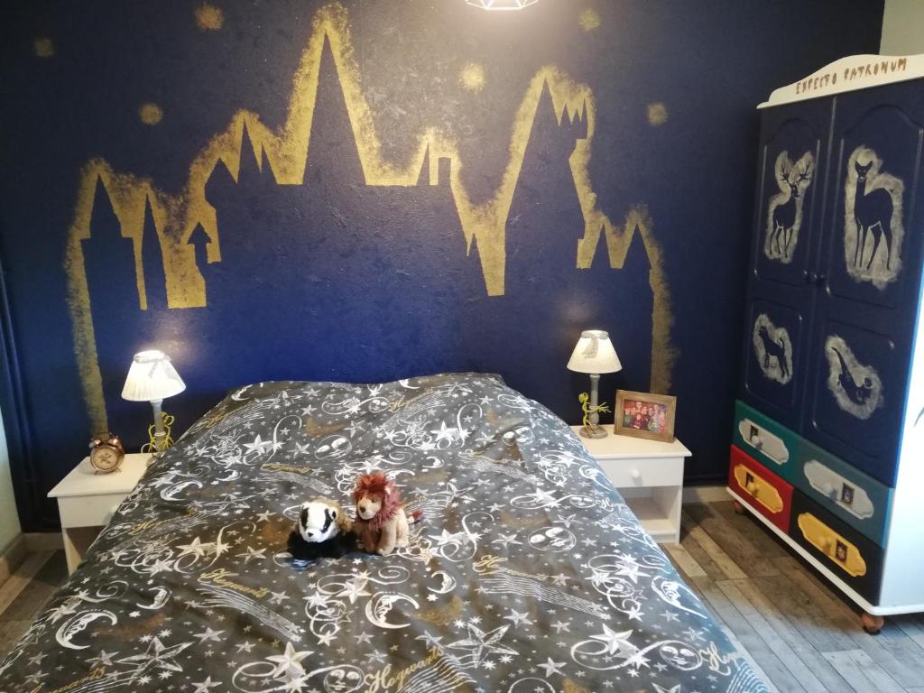 - une chambre avec un lit orné d'une fresque murale représentant une chauve-souris dans l'établissement l'antre du Sorcier (inspiré du monde Harry Potter), à Stosswihr