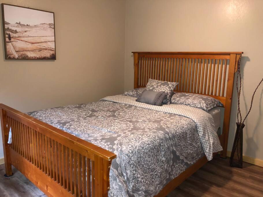 a bedroom with a bed with a wooden head board at Modern Cabin Get Away - close to APPLE HILL in Pollock Pines