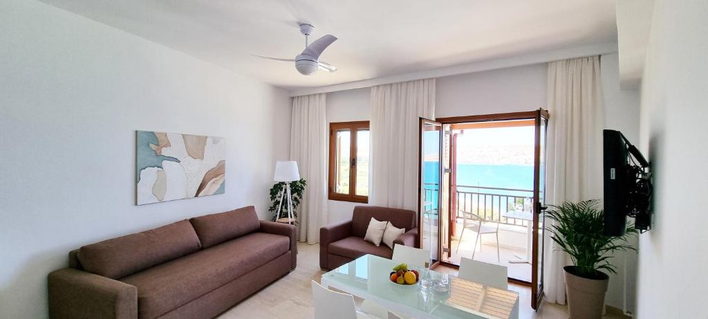 a living room with a couch and a table at Simon Sea View in Sitia