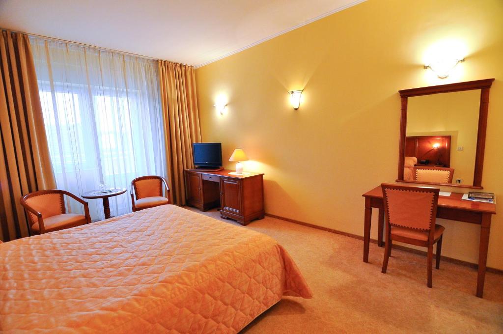Postel nebo postele na pokoji v ubytování Hotel Maxim