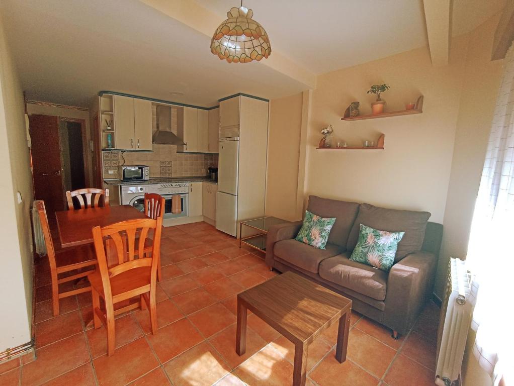 a living room with a couch and a table at El Rincón del Sanabrés, cabeza mediana in Rascafría