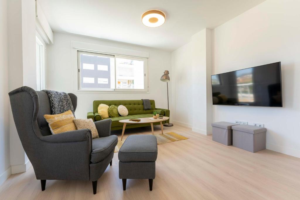 Televízia a/alebo spoločenská miestnosť v ubytovaní Apartamento de lujo de dos dormitorios