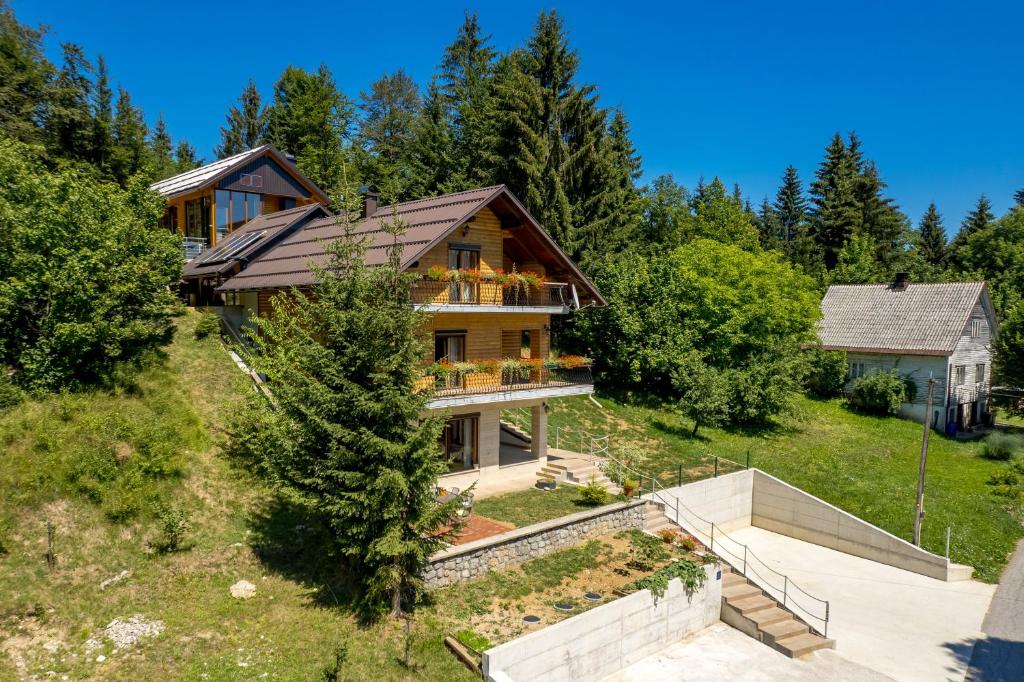 an aerial view of a house on a hill at Greenhouse Ella with heated pool in Tršće