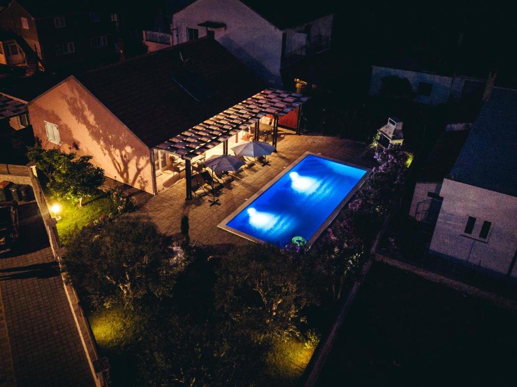 an overhead view of a swimming pool at night at Villa Magdalena, Biograd na Moru in Biograd na Moru