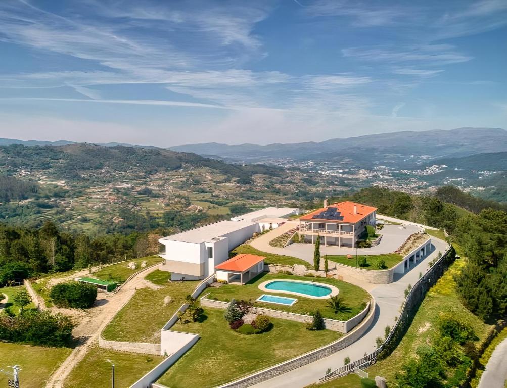 an aerial view of a house with a swimming pool at Hotel Cotto do Gatto in Ponte da Barca