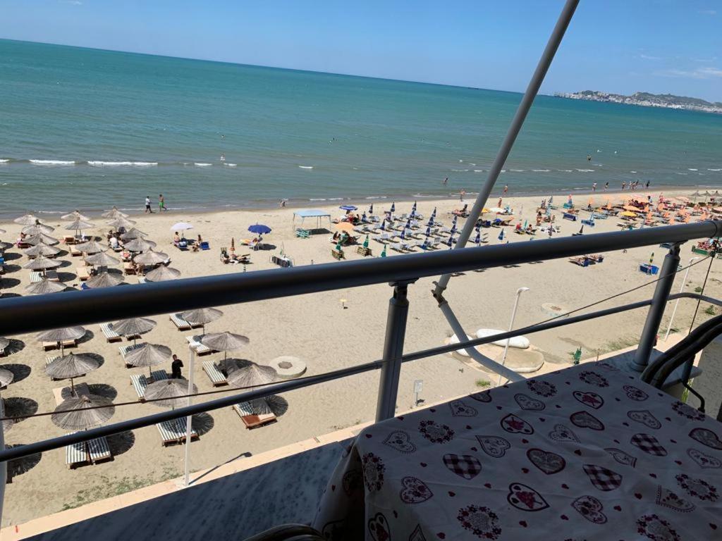 a view of a beach with umbrellas and the ocean at Isabel in Durrës