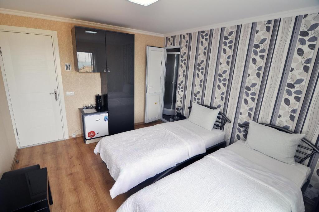 Postel nebo postele na pokoji v ubytování Aphra Hotel Tbilisi