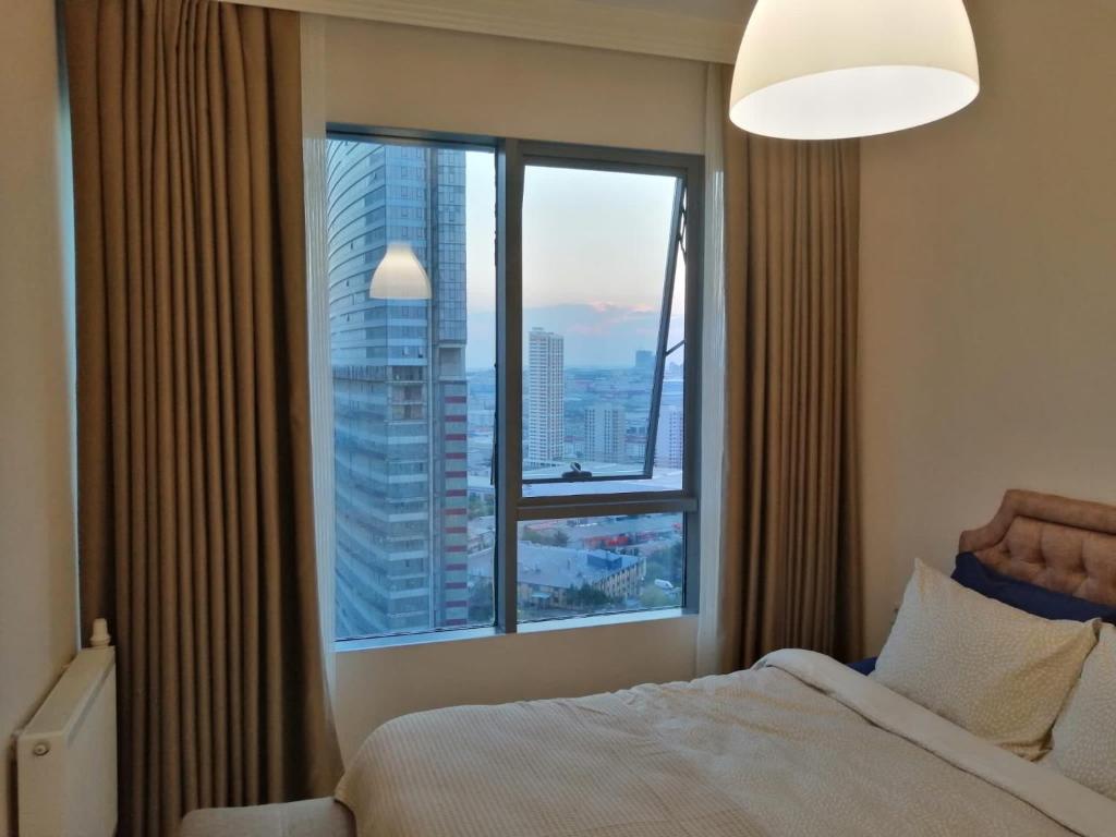 a bedroom with a bed and a large window at Kozza Park, next to Akbati Shopping Mall and Tennis Academy in Istanbul