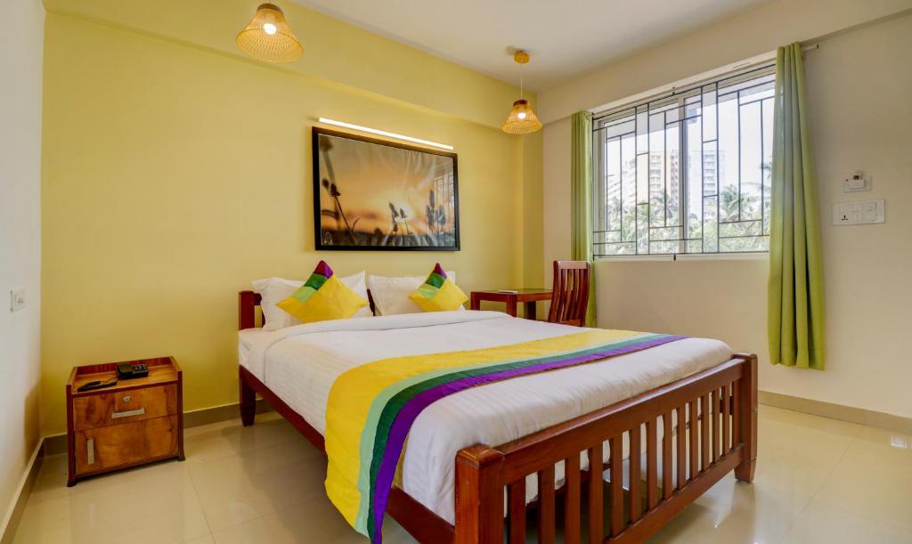 a bedroom with a large bed and a window at Itsy By Treebo - Ushodaya Royal Residency in Trivandrum