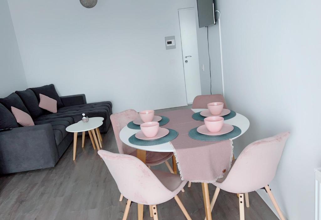 a living room with a table and chairs and a couch at Apartament Alexandra Ressidence in Oradea