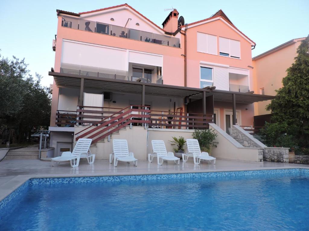a house with a swimming pool in front of a building at Berat Apartment in Vodnjan