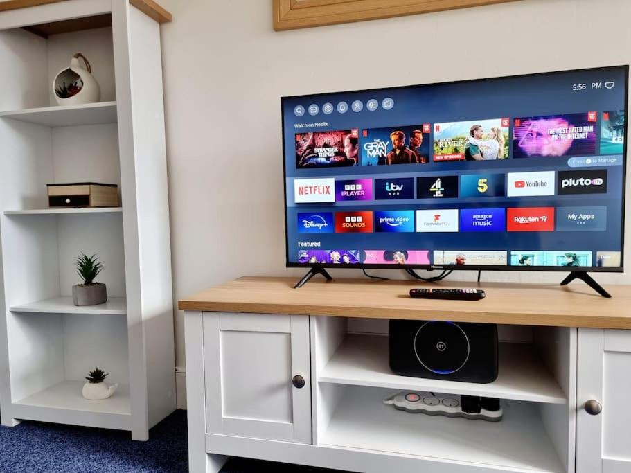 a flat screen tv sitting on top of a desk at One Bed Holiday Home in the Heart of Glasgow in Glasgow