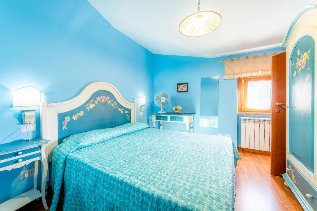 Un pat sau paturi într-o cameră la B&B Capriccio