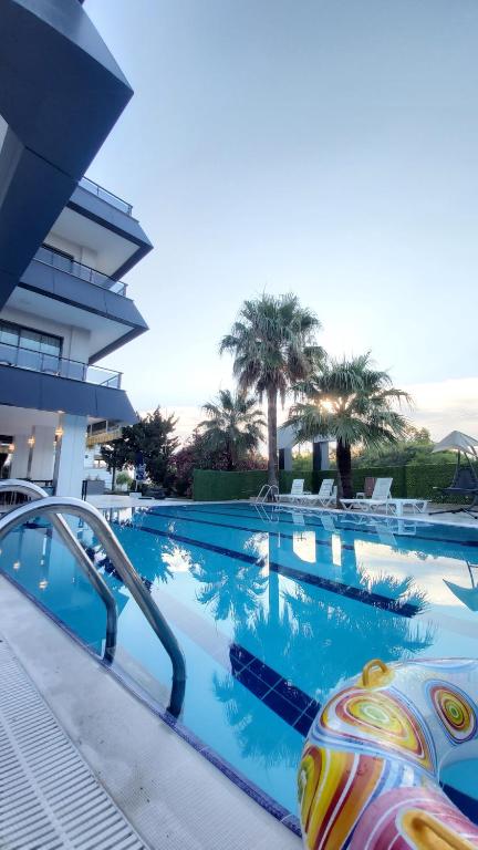 a swimming pool at a hotel with a resort at PALMİLA BUTİK OTEL in Silifke