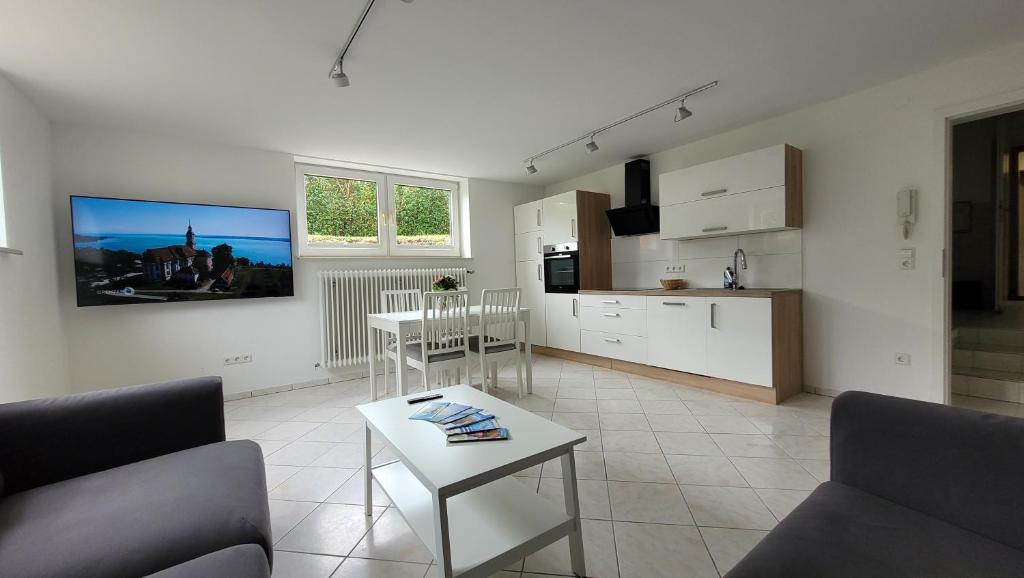 a living room with a couch and a table at Komfortable & moderne Ferienwohnung in Markdorf - Familie Hildebrand in Markdorf