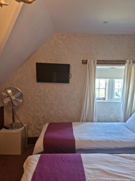 A bed or beds in a room at St Michaels Guest House