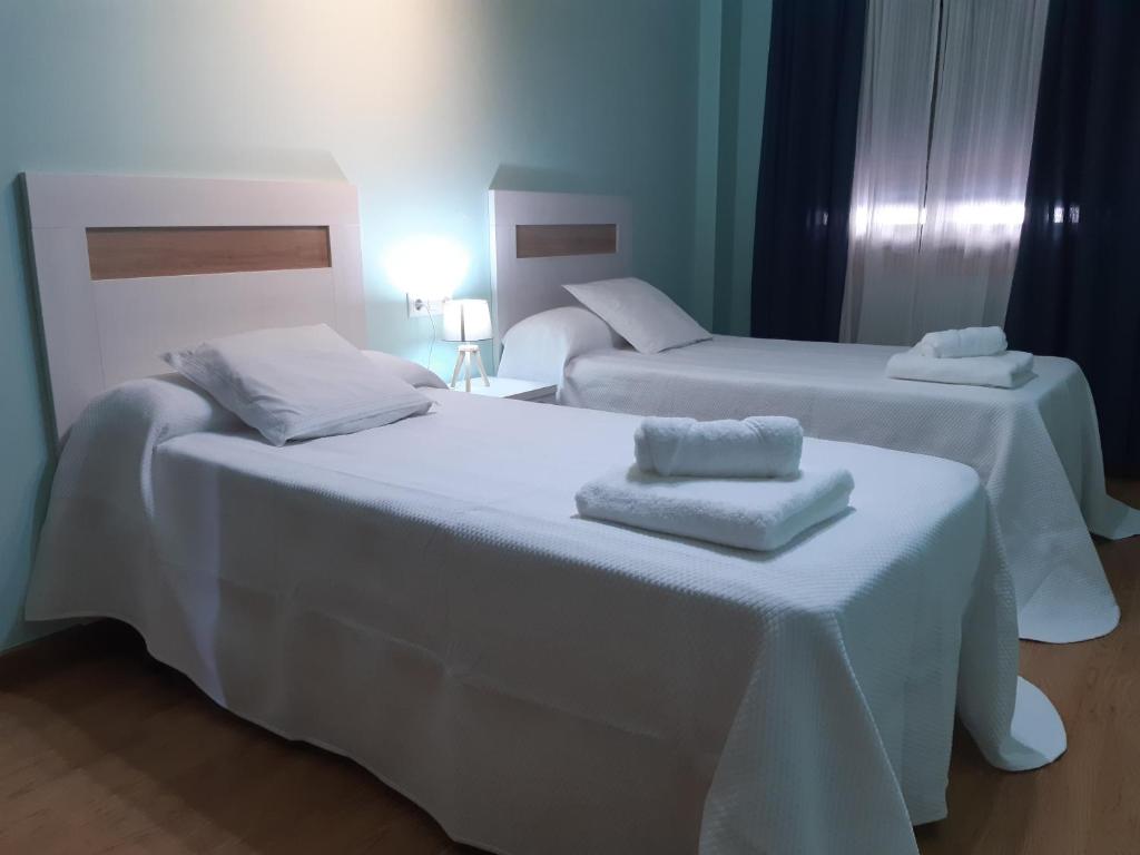 Posteľ alebo postele v izbe v ubytovaní Apartamento Reguiño al mar