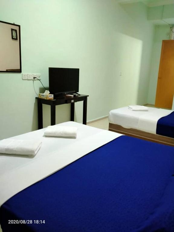 Postel nebo postele na pokoji v ubytování TAMIM SUITE GROUP HOTEL Dungun