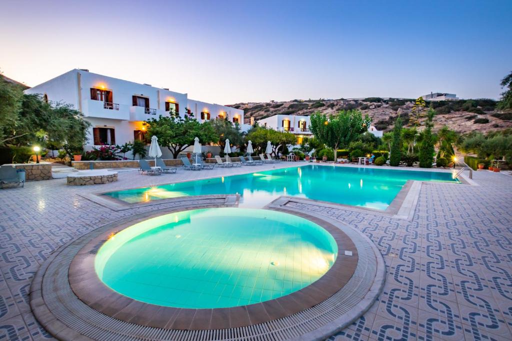 a swimming pool in a resort at dusk at Casa Garden in Karpathos
