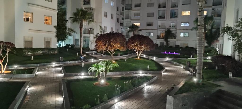 a courtyard in a building with trees and lights at Appartement Résidence fermée in Casablanca