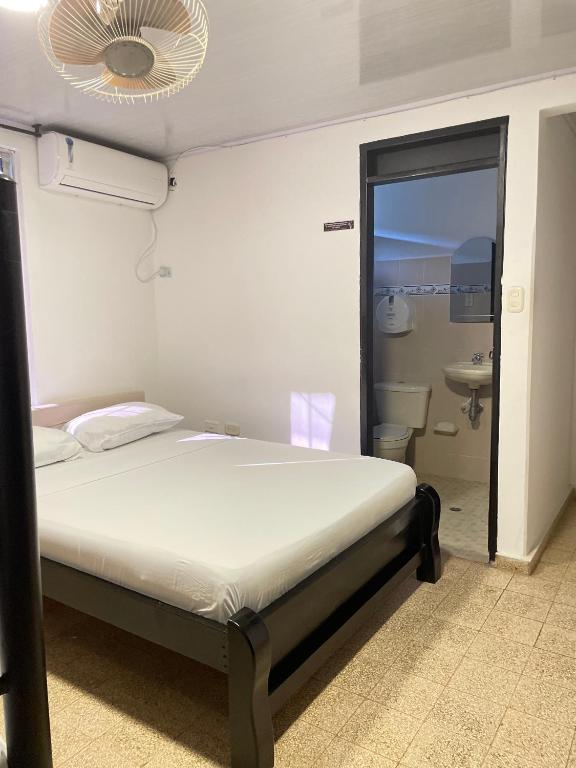 Postel nebo postele na pokoji v ubytování BOUTIQUE HOTEL BALOP Valledupar