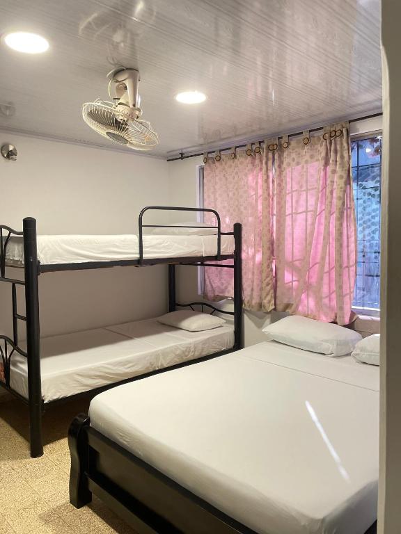 Postel nebo postele na pokoji v ubytování BOUTIQUE HOTEL BALOP Valledupar