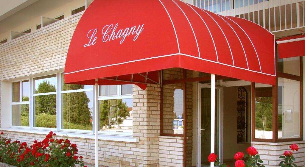 a red canopy on the front of a building at Le Chagny in Chagny