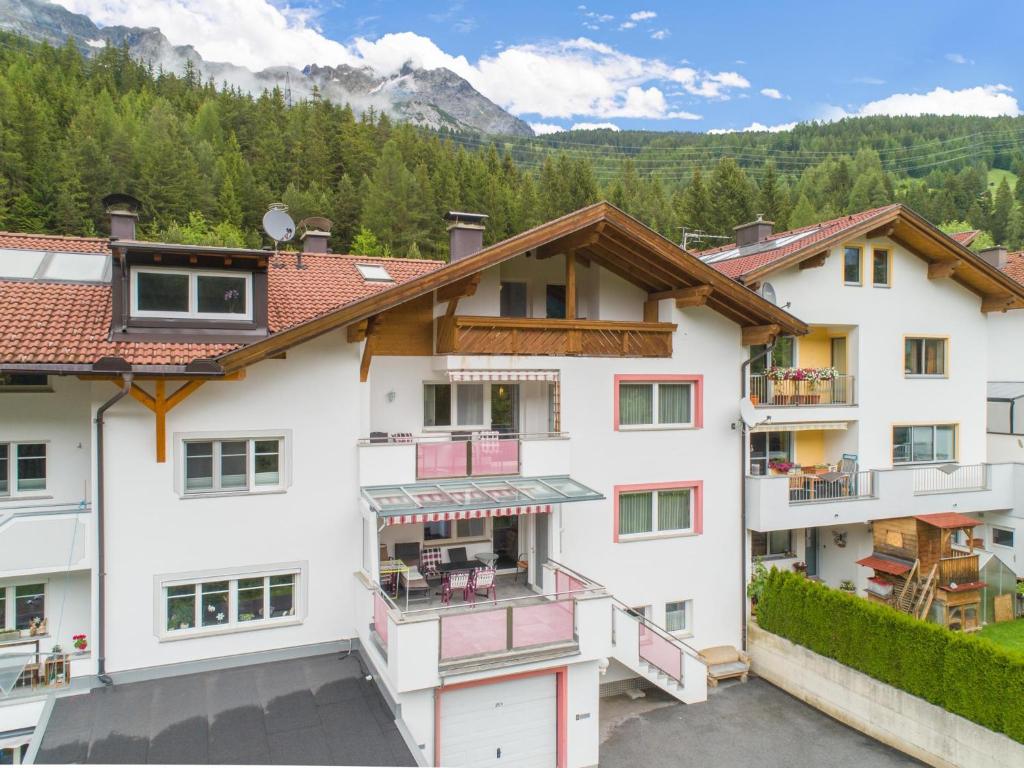 an apartment building with a balcony and mountains in the background at Seeberger I in Strengen