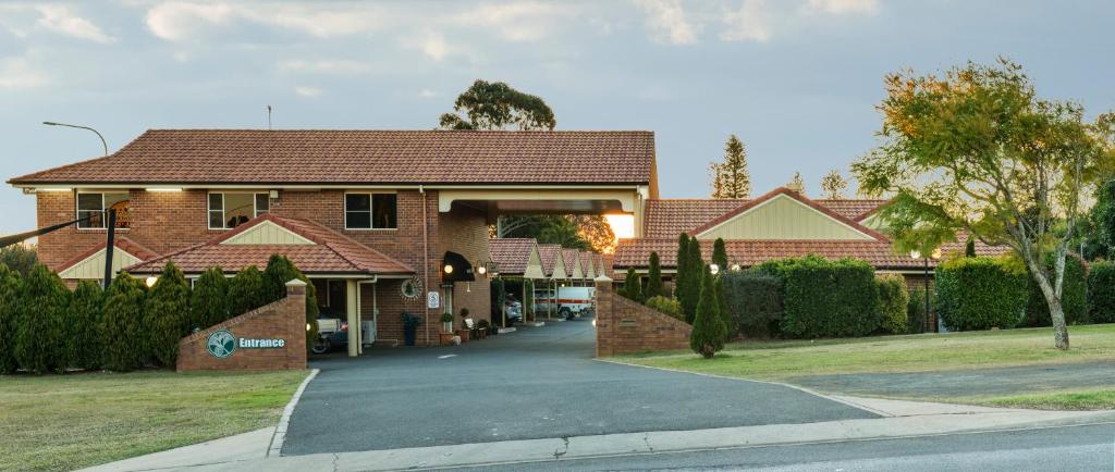 a house with a driveway in front of it at Cotswold Motor Inn in Toowoomba