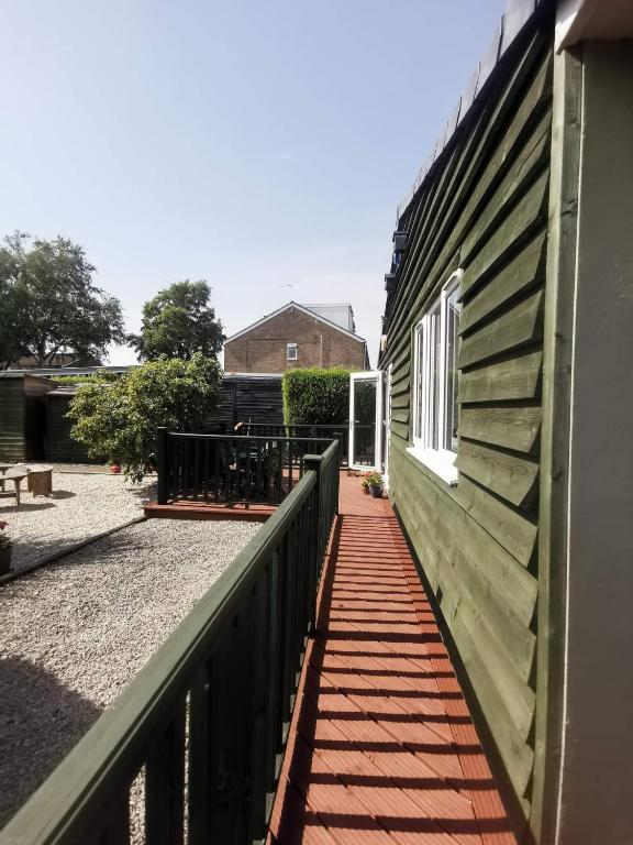 a porch of a house with a fence and a table at Green Street Retreat in York