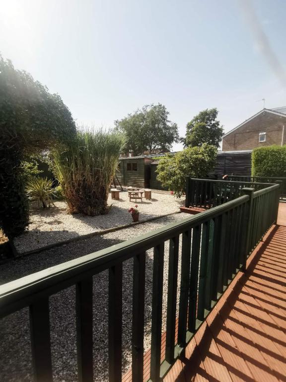a balcony with a fence and a yard at Green Street Retreat in York