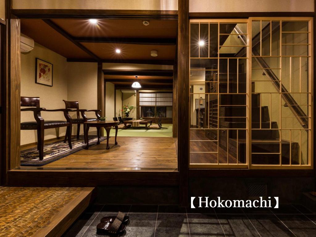una sala de estar con una gran puerta de cristal y un comedor. en Kyoisuke, en Kioto