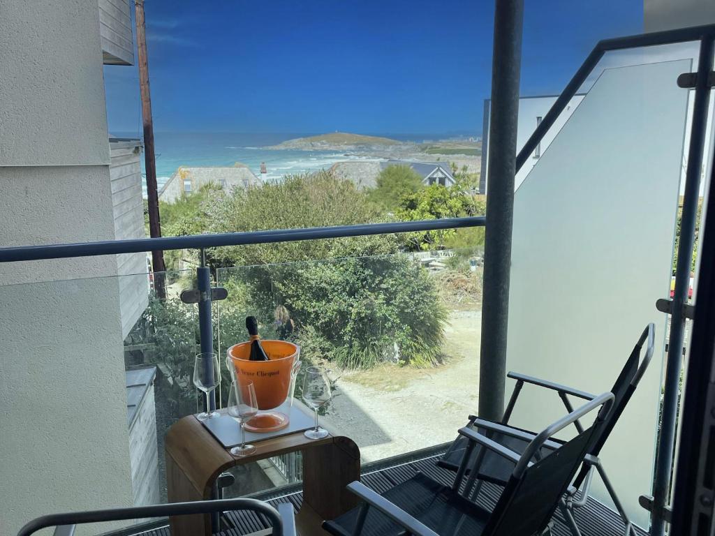 a balcony with two chairs and a view of the ocean at 17 Ocean one in Newquay