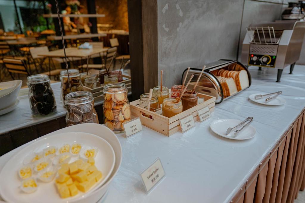 A breakfast toppings and toast station with fruit, spreads, jars, and a toaster.