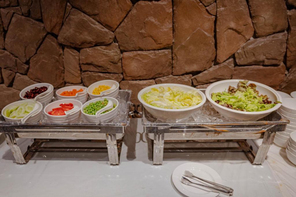 A compact buffet station with salad and vegetable toppings.