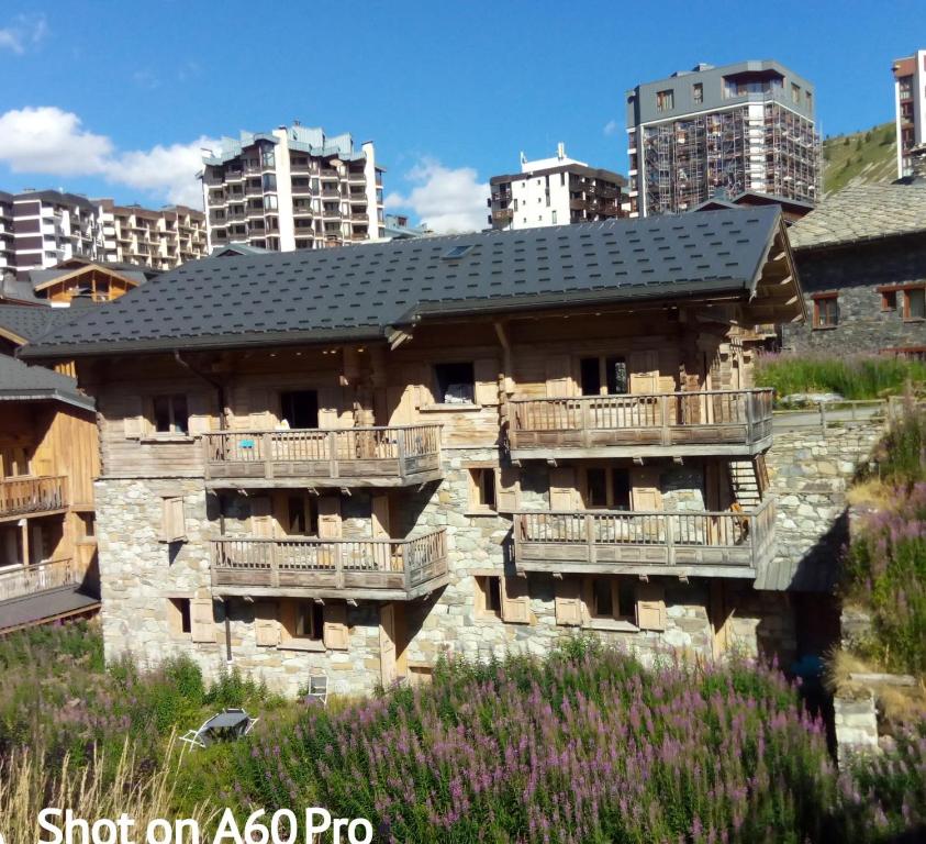 an old stone building with a black roof at Chalet Le Cordava in Tignes