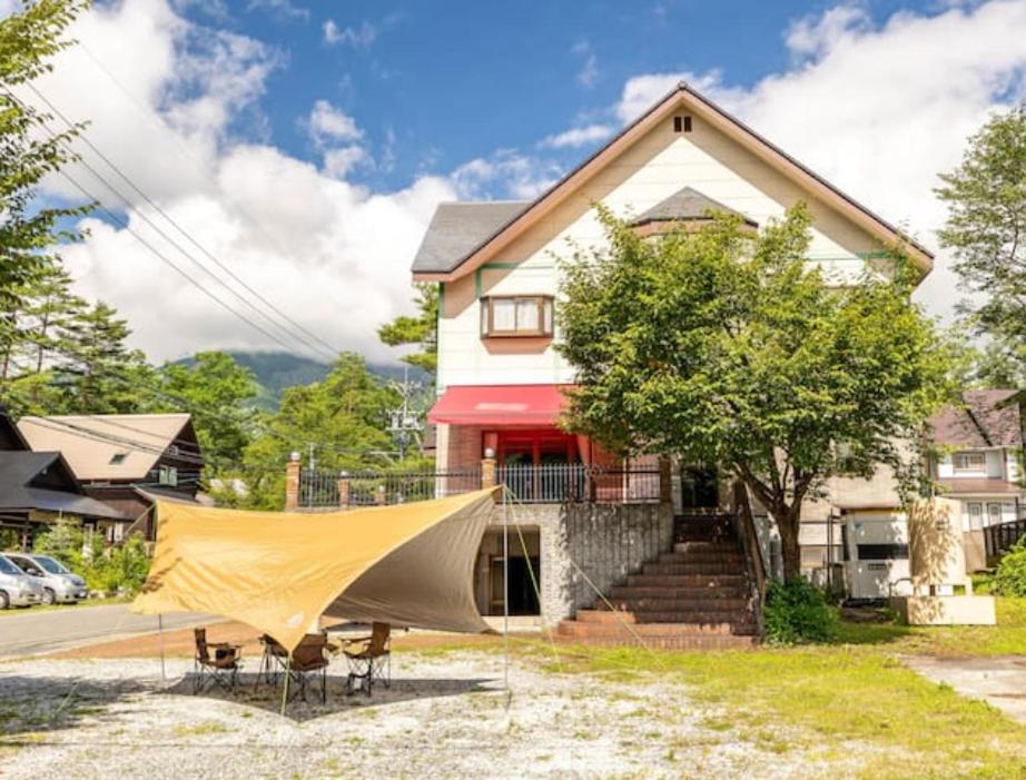 a house with a tent in front of it at Seventh Heaven Hakuba in Hakuba