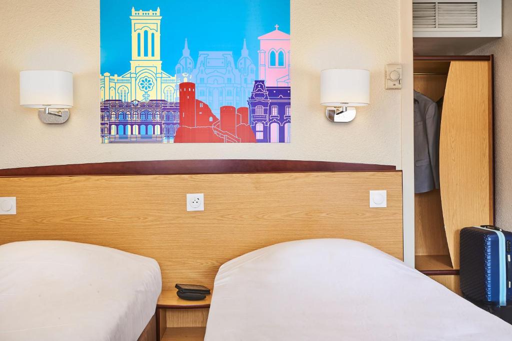 Una cama o camas en una habitaci&oacute;n de Kyriad Direct Lyon Sud - Chasse-Sur-Rh&ocirc;ne