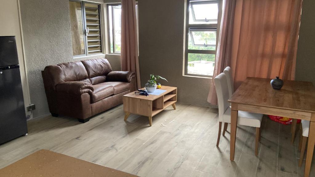 a living room with a couch and a table at City Apartments in Port Louis