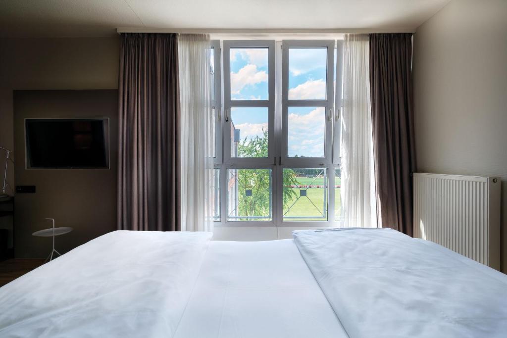 Postel nebo postele na pokoji v ubytování Seminaris Hotel Nürnberg