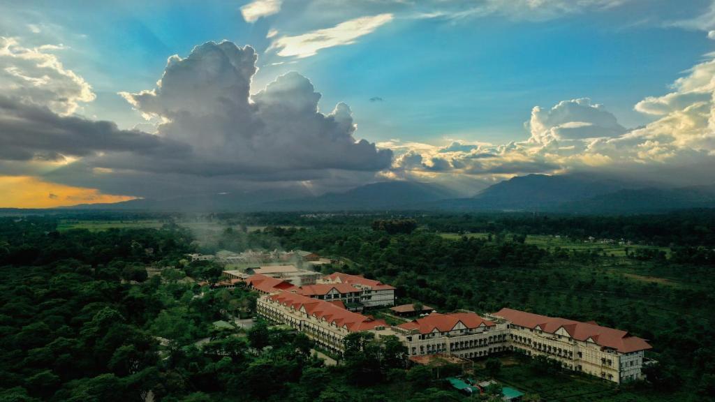 an aerial view of a city with buildings and trees at MAYFAIR Tea Resort in Siliguri