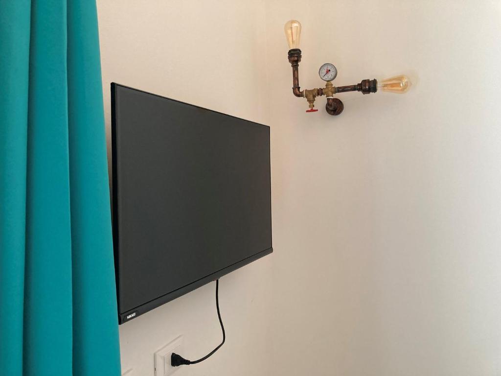 TV a/nebo společenská místnost v ubytování AL RUDERINO