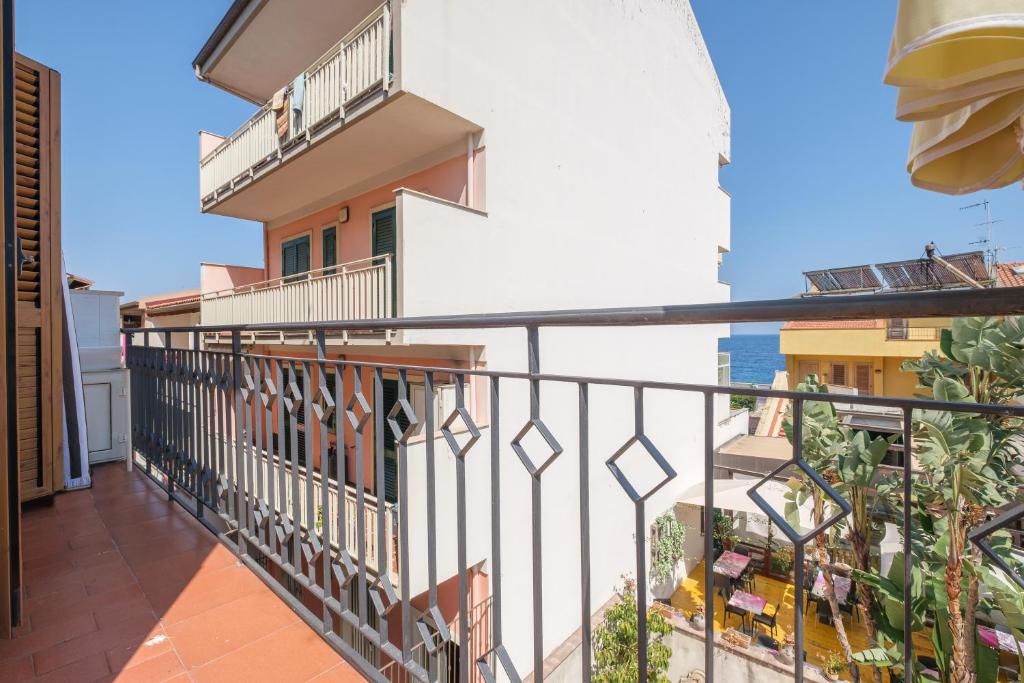 a balcony with a view of the ocean at Casa Olimpia in Santa Teresa di Riva