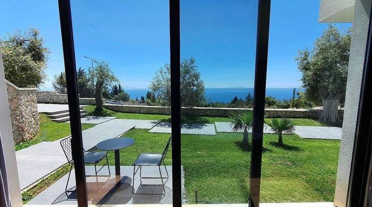 a view of a patio with a table and chairs at Le Rêve Boutique Hotel in Dhërmi
