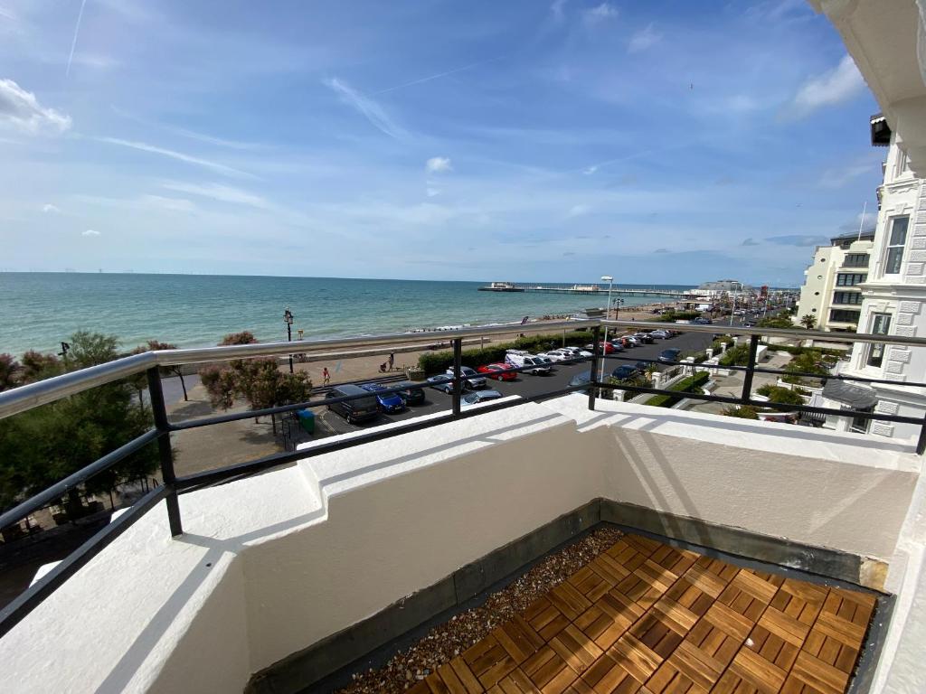 a balcony with a view of the ocean at Splashpoint with FREE parking in Worthing